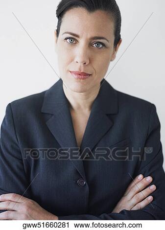 Stock Image - Portrait of a businesswoman smirking with her arms crossed. Fotosearch