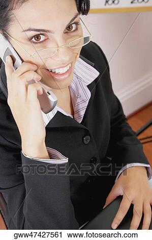 Portrait of a businesswoman using a mobile phone and smiling View Large Photo Image Stock Image - Portrait of a businesswoman using a mobile phone and smiling. Fotosearch