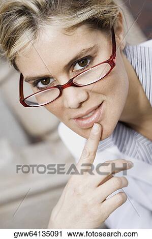 Stock Image - Portrait of a businesswoman with her finger on her chin. Fotosearch
