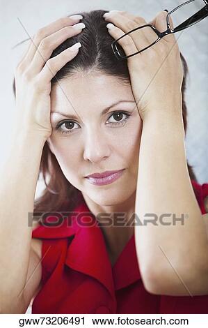 Portrait of a businesswoman with her hands on her head View Large Photo Image Stock Image - Portrait of a businesswoman with her hands on her head. Fotosearch
