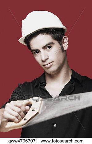 Portrait of a carpenter holding a saw View Large Photo Image Stock Image - Portrait of a carpenter holding a saw. Fotosearch