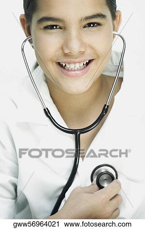 Stock Image - Portrait of a girl checking her heart rate with a stethoscope. Fotosearch