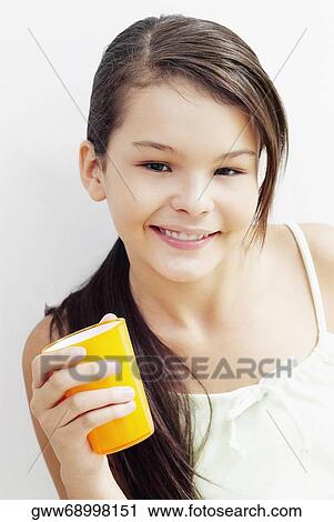 Portrait of a girl holding a glass and smiling View Large Photo Image Stock Image - Portrait of a girl holding a glass and smiling. Fotosearch