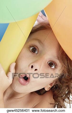 Portrait of a girl holding balloons and puckering her lips View Large Photo Image Stock Image - Portrait of a girl holding balloons and puckering her lips. Fotosearch