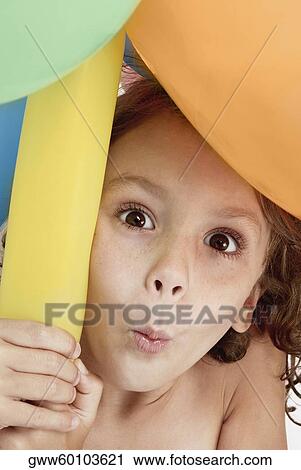 Portrait of a girl holding balloons and puckering her lips View Large Photo Image Stock Image - Portrait of a girl holding balloons and puckering her lips. Fotosearch