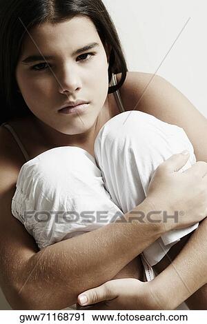 Portrait of a girl hugging her knees View Large Photo Image Stock Image - Portrait of a girl hugging her knees. Fotosearch