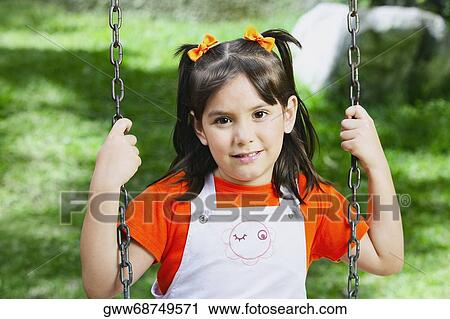 Portrait of a girl on a chain swing ride View Large Photo Image Stock Image - Portrait of a girl on a chain swing ride. Fotosearch
