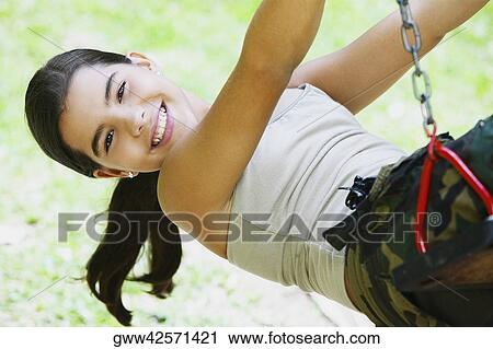 Portrait of a girl smiling on a chain swing ride View Large Photo Image Stock Image - Portrait of a girl smiling on a chain swing ride. Fotosearch