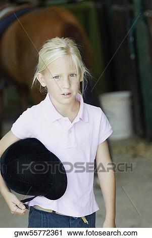 Portrait of a girl standing and holding sports helmet View Large Photo Image Stock Image - Portrait of a girl standing and holding sports helmet. Fotosearch