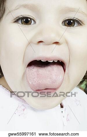 Portrait of a girl sticking her tongue out View Large Photo Image Stock Image - Portrait of a girl sticking her tongue out. Fotosearch