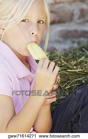 Portrait of a girl sucking an ice-cream View Large Photo Image Stock Image - Portrait of a girl sucking an ice-cream. Fotosearch