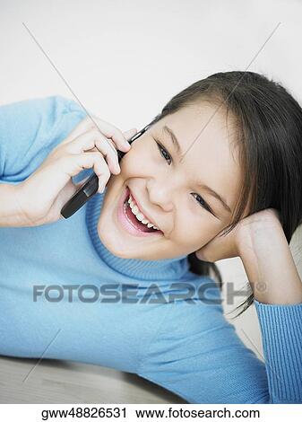 Portrait of a girl using a mobile phone and smiling View Large Photo Image Stock Image - Portrait of a girl using a mobile phone and smiling. Fotosearch