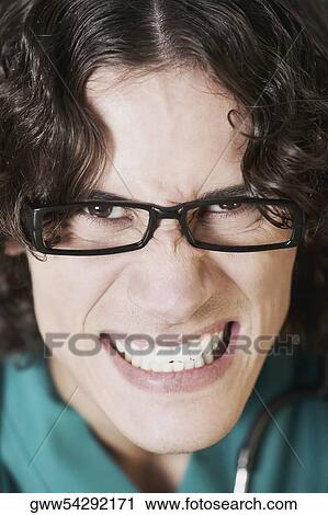 Portrait of a male doctor clenching his teeth View Large Photo Image Stock Image - Portrait of a male doctor clenching his teeth. Fotosearch