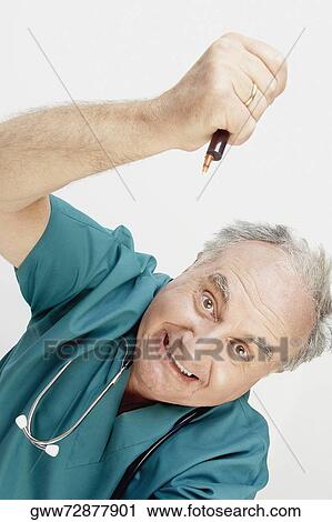 Portrait of a male doctor holding a pen View Large Photo Image Stock Image - Portrait of a male doctor holding a pen. Fotosearch