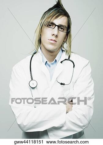 Portrait of a male doctor standing with his arms crossed View Large Photo Image Stock Image - Portrait of a male doctor standing with his arms crossed. Fotosearch