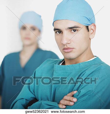 Portrait of a male doctor with a female doctor in the background View Large Photo Image Stock Image - Portrait of a male doctor with a female doctor in the background. Fotosearch