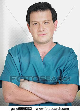 Portrait of a male doctor with his arms crossed View Large Photo Image Stock Image - Portrait of a male doctor with his arms crossed. Fotosearch