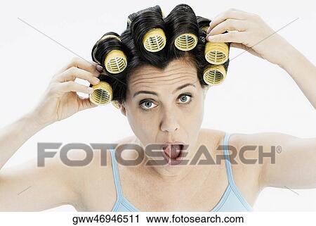 Portrait of a mature woman adjusting her hair curlers looking shocked View Large Photo Image Stock Image - Portrait of a mature woman adjusting her hair curlers looking shocked. Fotosearch