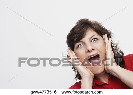 Stock Image - Portrait of a mature woman looking surprised. Fotosearch