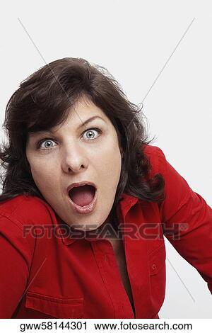 Stock Image - Portrait of a mature woman looking surprised with her mouth open. Fotosearch