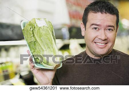 Portrait of a mid adult man holding chicory and smiling View Large Photo Image Stock Image - Portrait of a mid adult man holding chicory and smiling. Fotosearch