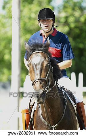 Portrait of a mid adult man horseback riding View Large Photo Image Stock Image - Portrait of a mid adult man horseback riding. Fotosearch