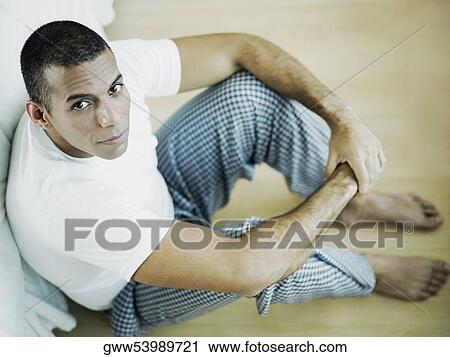 Portrait of a mid adult man sitting on the floor View Large Photo Image Stock Image - Portrait of a mid adult man sitting on the floor. Fotosearch
