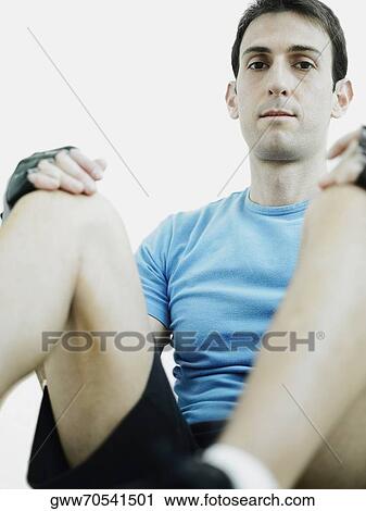 Portrait of a mid adult man sitting with his hands on his knees View Large Photo Image Stock Image - Portrait of a mid adult man sitting with his hands on his knees. Fotosearch