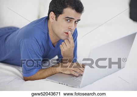 Portrait of a mid adult man using a laptop View Large Photo Image Stock Image - Portrait of a mid adult man using a laptop. Fotosearch