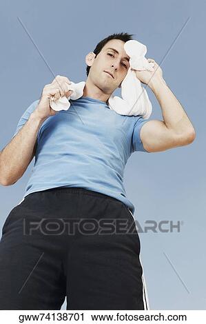 Portrait of a mid adult man wiping his face with a towel View Large Photo Image Stock Image - Portrait of a mid adult man wiping his face with a towel. Fotosearch