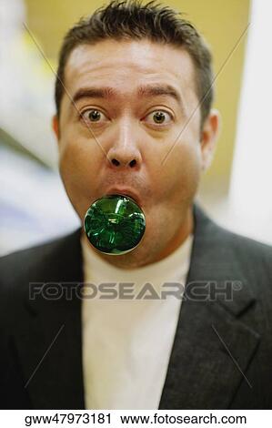 Portrait of a mid adult man with a light bulb in his mouth View Large Photo Image Stock Image - Portrait of a mid adult man with a light bulb in his mouth. Fotosearch