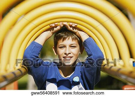 Portrait of a teenage boy on a jungle gym View Large Photo Image Stock Image - Portrait of a teenage boy on a jungle gym. Fotosearch