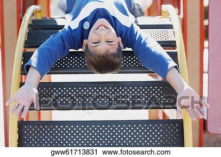 Portrait of a teenage boy playing on a jungle gym View Large Photo Image Stock Image - Portrait of a teenage boy playing on a jungle gym. Fotosearch