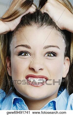 Portrait of a teenage girl clenching her teeth and pulling her hair View Large Photo Image Stock Image - Portrait of a teenage girl clenching her teeth and pulling her hair. Fotosearch