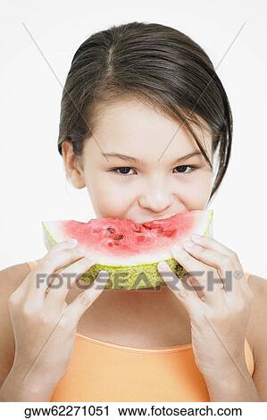 Portrait of a teenage girl eating a slice of watermelon View Large Photo Image Stock Image - Portrait of a teenage girl eating a slice of watermelon. Fotosearch