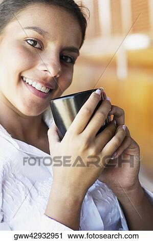 Portrait of a teenage girl holding a cup View Large Photo Image Stock Image - Portrait of a teenage girl holding a cup. Fotosearch