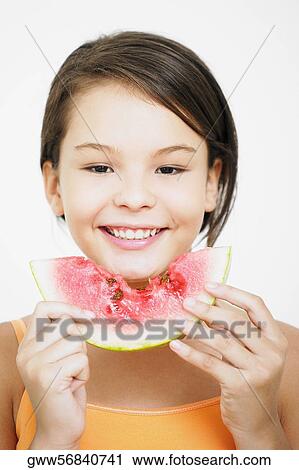 Portrait of a teenage girl holding a slice of watermelon View Large Photo Image Stock Image - Portrait of a teenage girl holding a slice of watermelon. Fotosearch