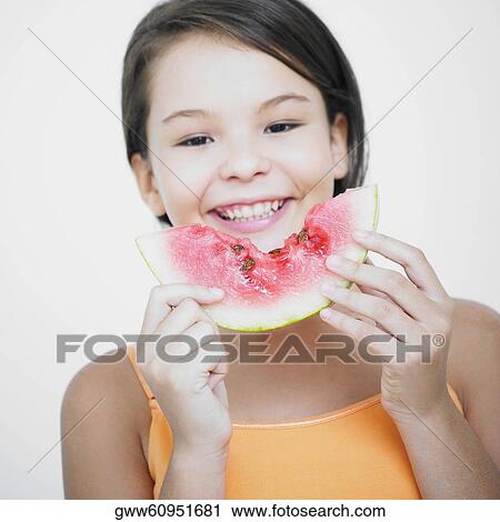 Portrait of a teenage girl holding a slice of watermelon View Large Photo Image Stock Image - Portrait of a teenage girl holding a slice of watermelon. Fotosearch