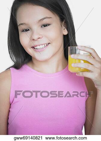 Portrait of a teenage girl holding a glass of juice and smiling View Large Photo Image Stock Image - Portrait of a teenage girl holding a glass of juice and smiling. Fotosearch