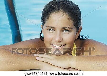 Portrait of a teenage girl leaning at the poolside View Large Photo Image Stock Image - Portrait of a teenage girl leaning at the poolside. Fotosearch