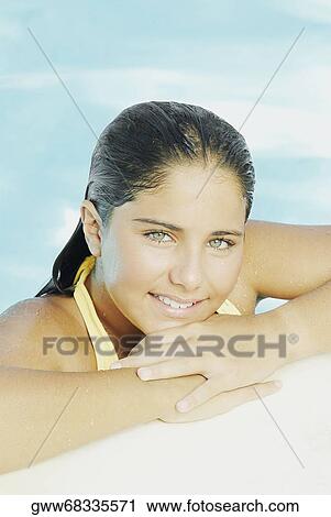 Portrait of a teenage girl leaning at the poolside View Large Photo Image Stock Image - Portrait of a teenage girl leaning at the poolside. Fotosearch