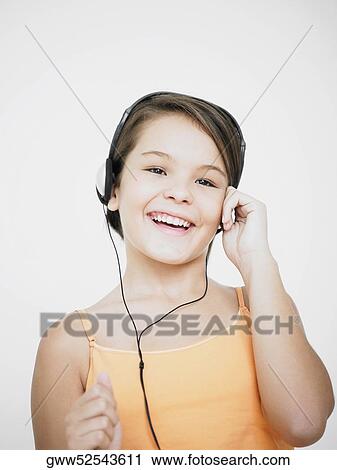 Stock Image - Portrait of a teenage girl listening to music. Fotosearch