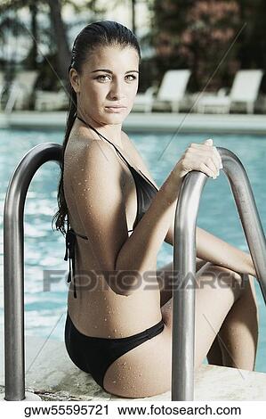 Portrait of a teenage girl sitting at the poolside View Large Photo Image Stock Image - Portrait of a teenage girl sitting at the poolside. Fotosearch