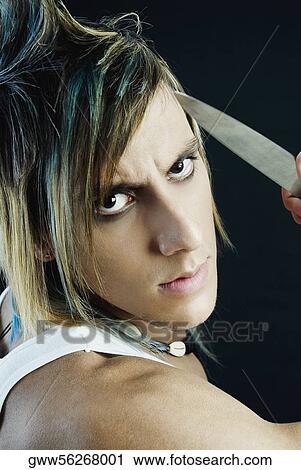 Portrait of a young man holding a knife and staring View Large Photo Image Stock Image - Portrait of a young man holding a knife and staring. Fotosearch