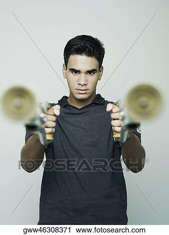 Portrait of a young man holding a pair of crutches View Large Photo Image Stock Image - Portrait of a young man holding a pair of crutches. Fotosearch