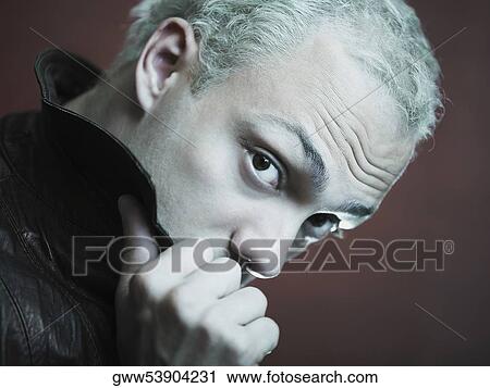 Portrait of a young man holding up his collar View Large Photo Image Stock Image - Portrait of a young man holding up his collar. Fotosearch
