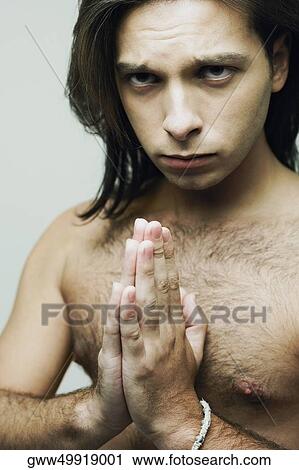 Portrait of a young man in a prayer position View Large Photo Image Stock Image - Portrait of a young man in a prayer position. Fotosearch
