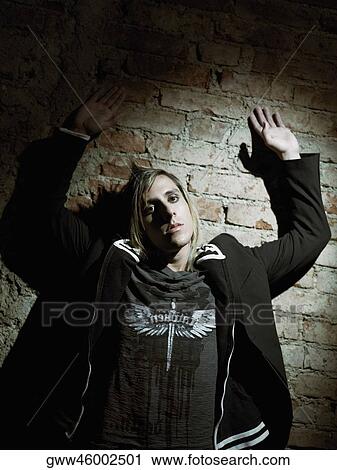 Portrait of a young man leaning against a brick wall View Large Photo Image Stock Image - Portrait of a young man leaning against a brick wall. Fotosearch