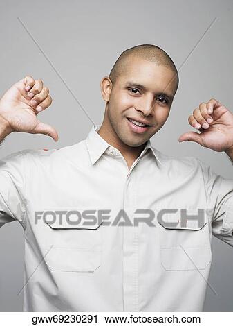 Portrait of a young man pointing at himself View Large Photo Image Stock Image - Portrait of a young man pointing at himself. Fotosearch