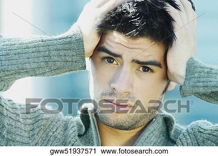 Portrait of a young man suffering from a headache View Large Photo Image Stock Image - Portrait of a young man suffering from a headache. Fotosearch